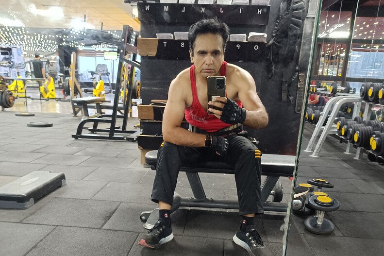 Fitness coach training in gym helping adults over 40 build strength and confidence